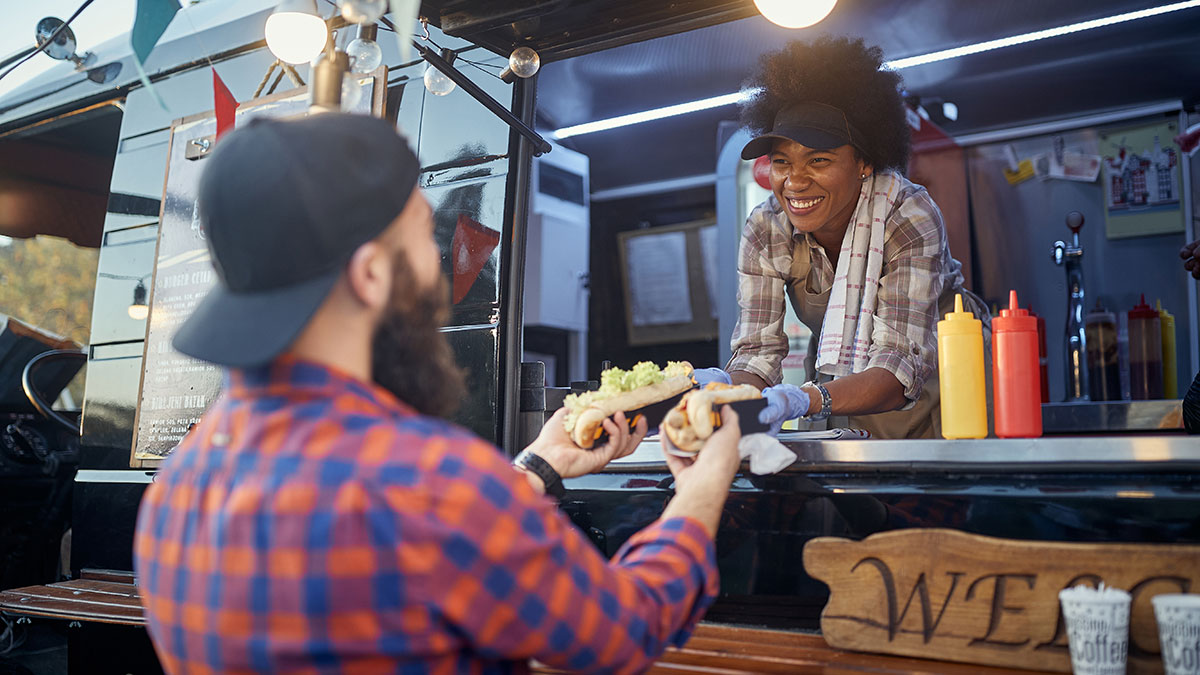 Man purchasing sandwiches from a local food truck