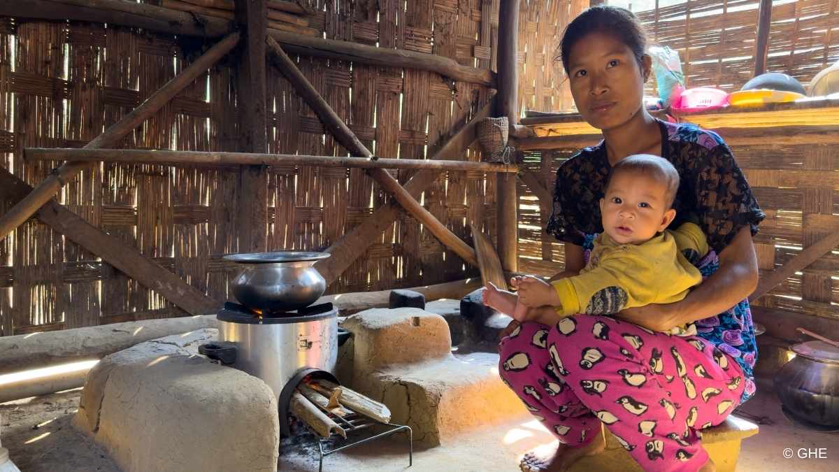 Woman preparing a meal using a clean cookstove provided by a carbon offset project in India’s Garo Hills which reduces indoor air pollution.