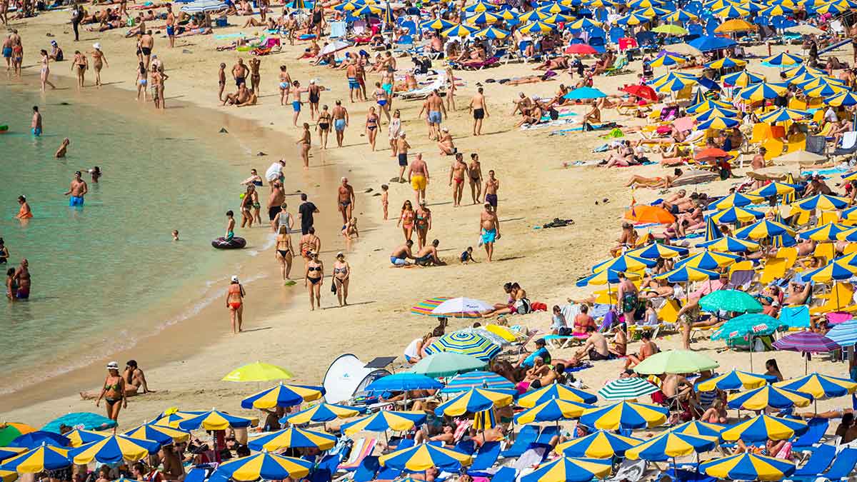 Tourists crowd a beach in Gran Canaria, which has been dealing with overtourism