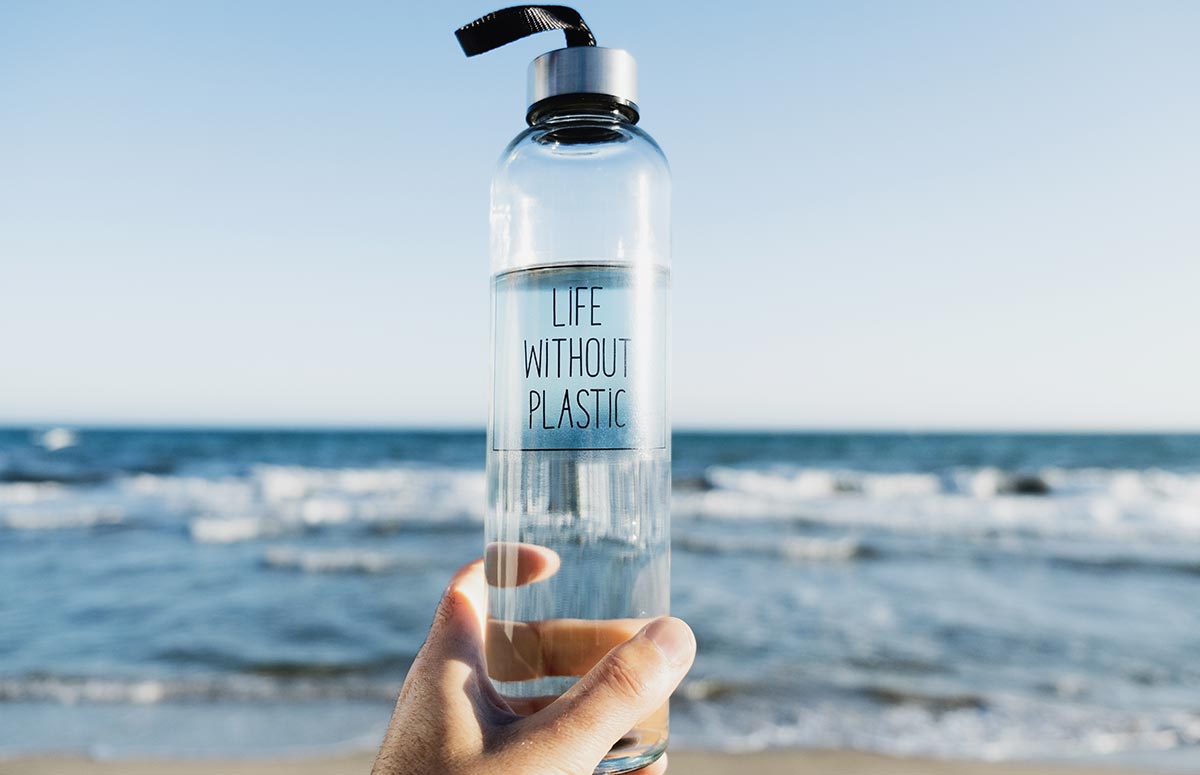 Traveler holding resusable water bottle