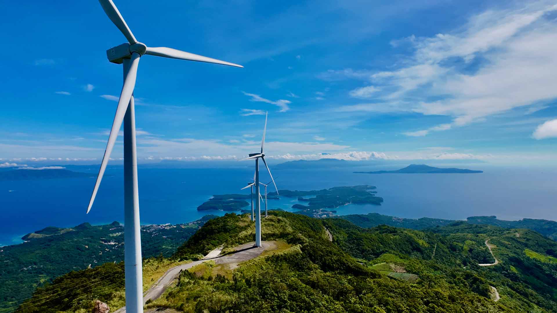 Wind turbines generating renewable energy on an island, a type of project that can be supported through carbon offsets