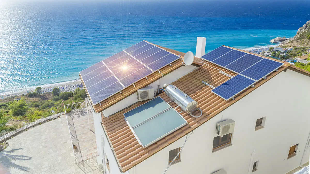 Solar panels on the roof of a building near the sea