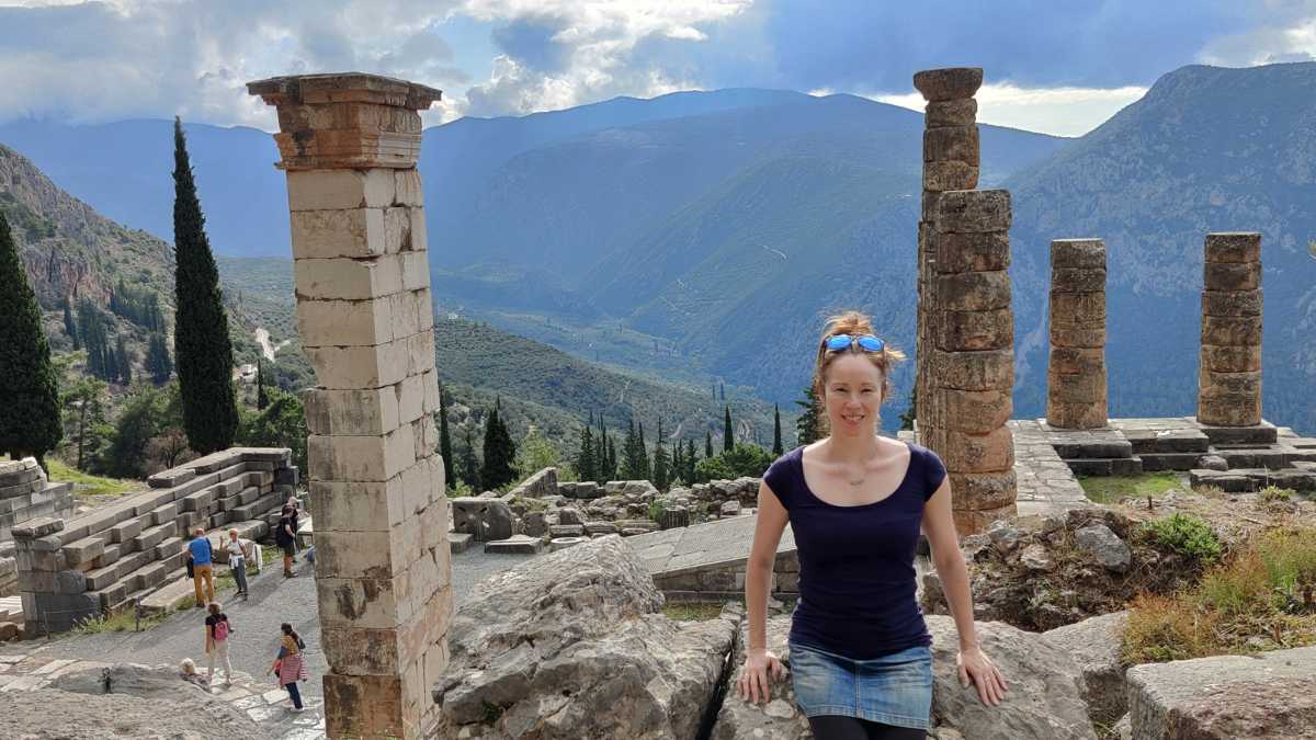 Amanda poses in front of ancient pillars in Greece