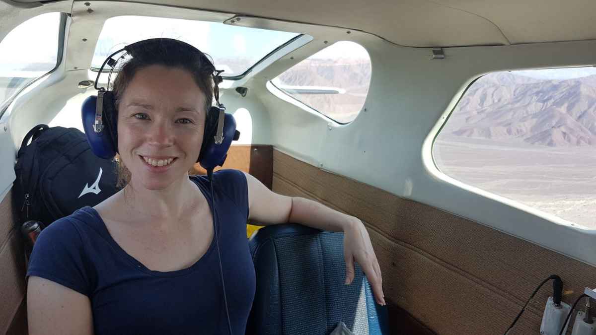 Amanda sits in a small plane