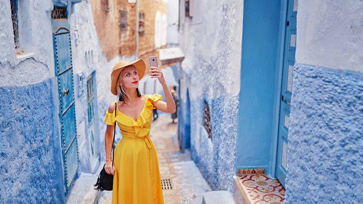 An influencer walks around Chefchaouen, Morocco which has gone viral on the internet