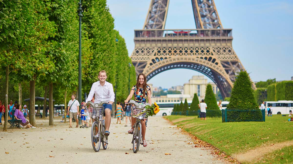 Two eco-friendly tourists biking around Paris