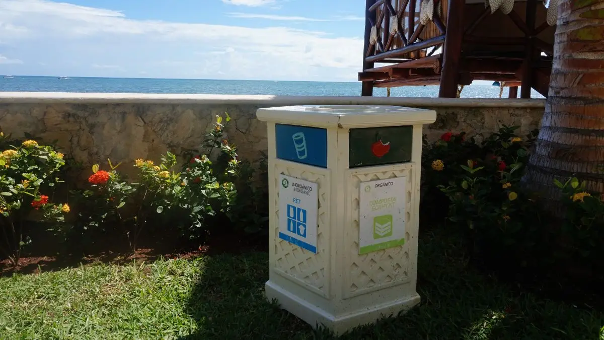 A recycling bin near the beach with waste labels