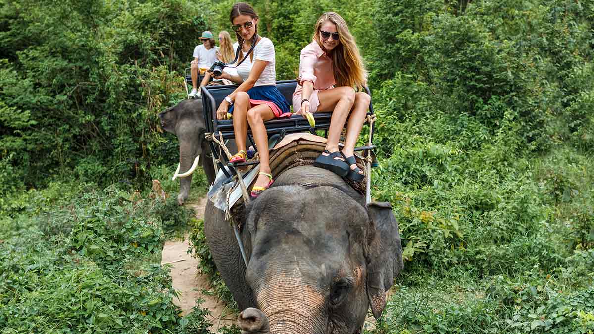 Tourists riding an elephant in Asia