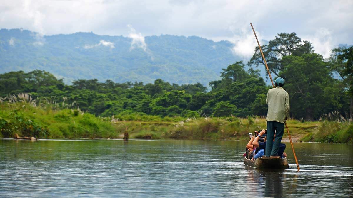 A local ecotourism guide navigates Chitwan National Park in Nepal