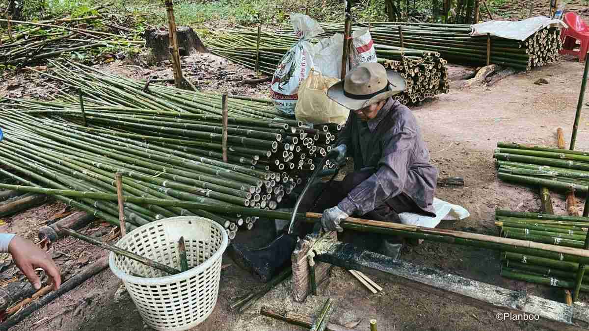 A man cuts bamboo at Wongphai Biochar in Thailand