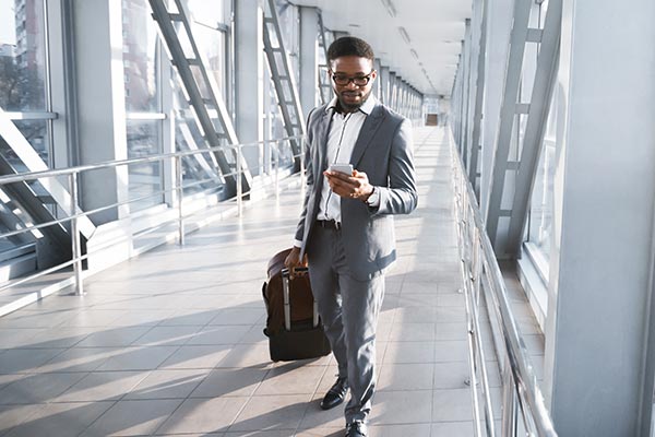 Corporate business traveler walking through airport