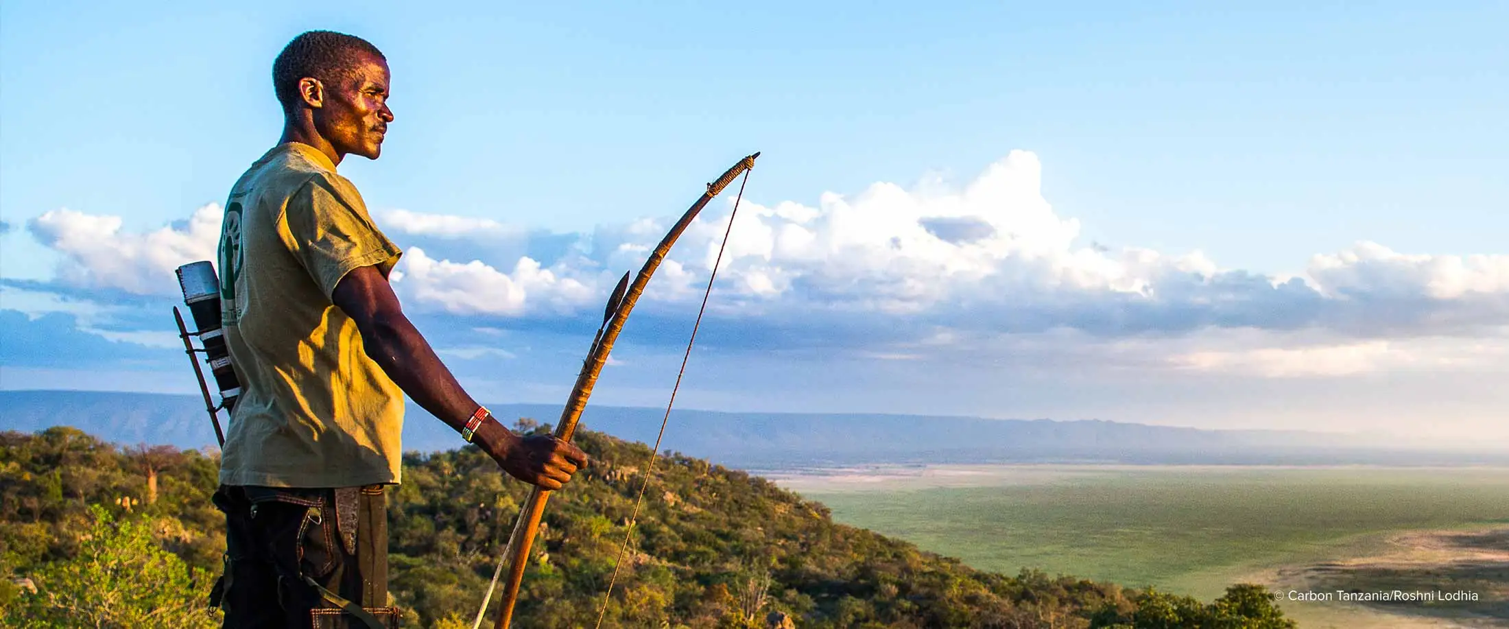 A member of the indigenous Hadza community stands on Gideru Rock overlooking the Yaeda Valley project area