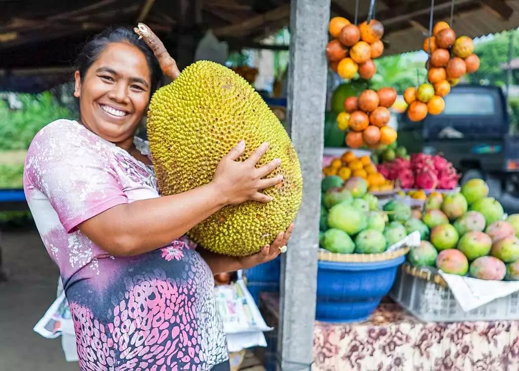 Local woman holding jackfruit