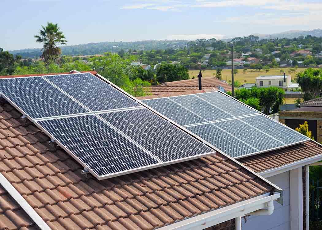 Solar panels on a building rooftop, a way to reduce carbon emissions