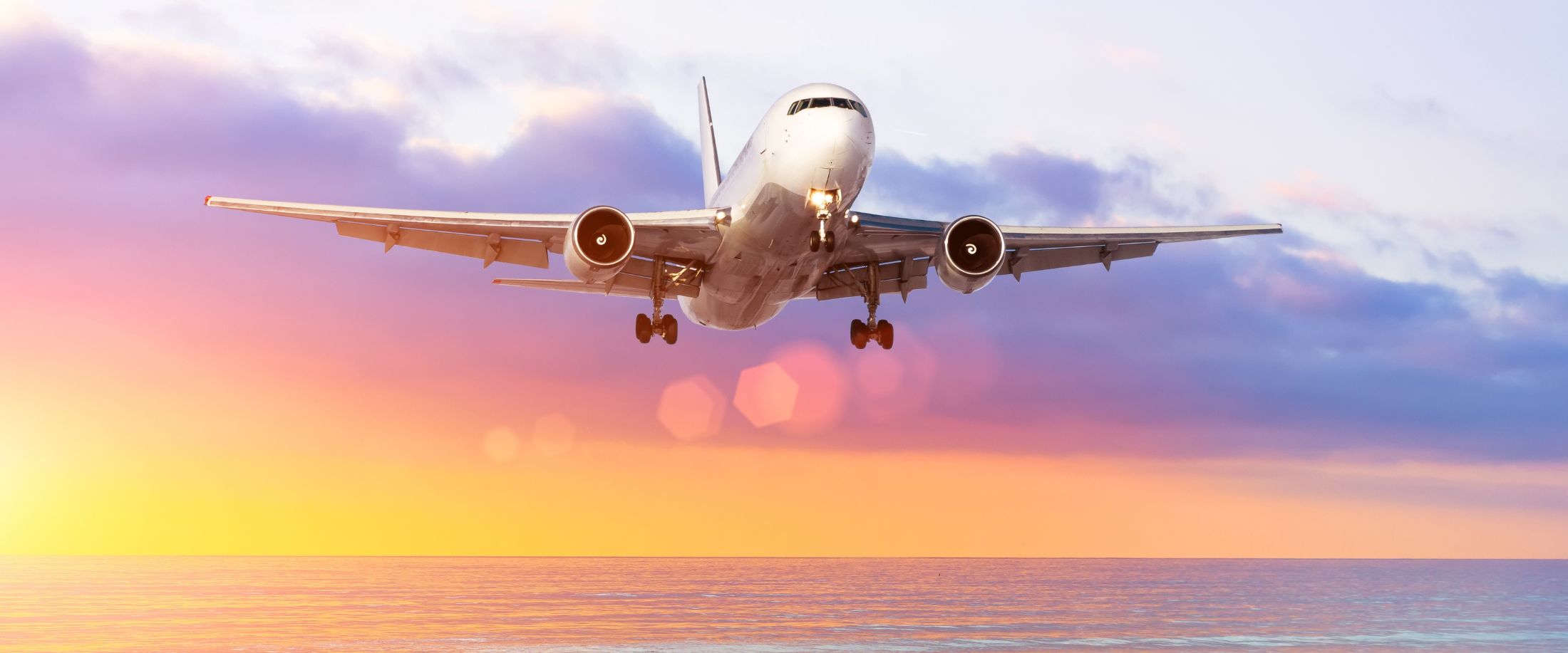 View of the evening sea horizon, with a landing airplane airport