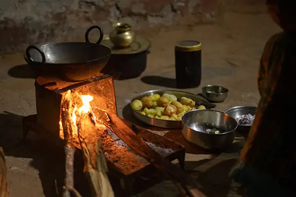 Traditional mud cookstoves being used by a family that generate emissions and harmful pollution.