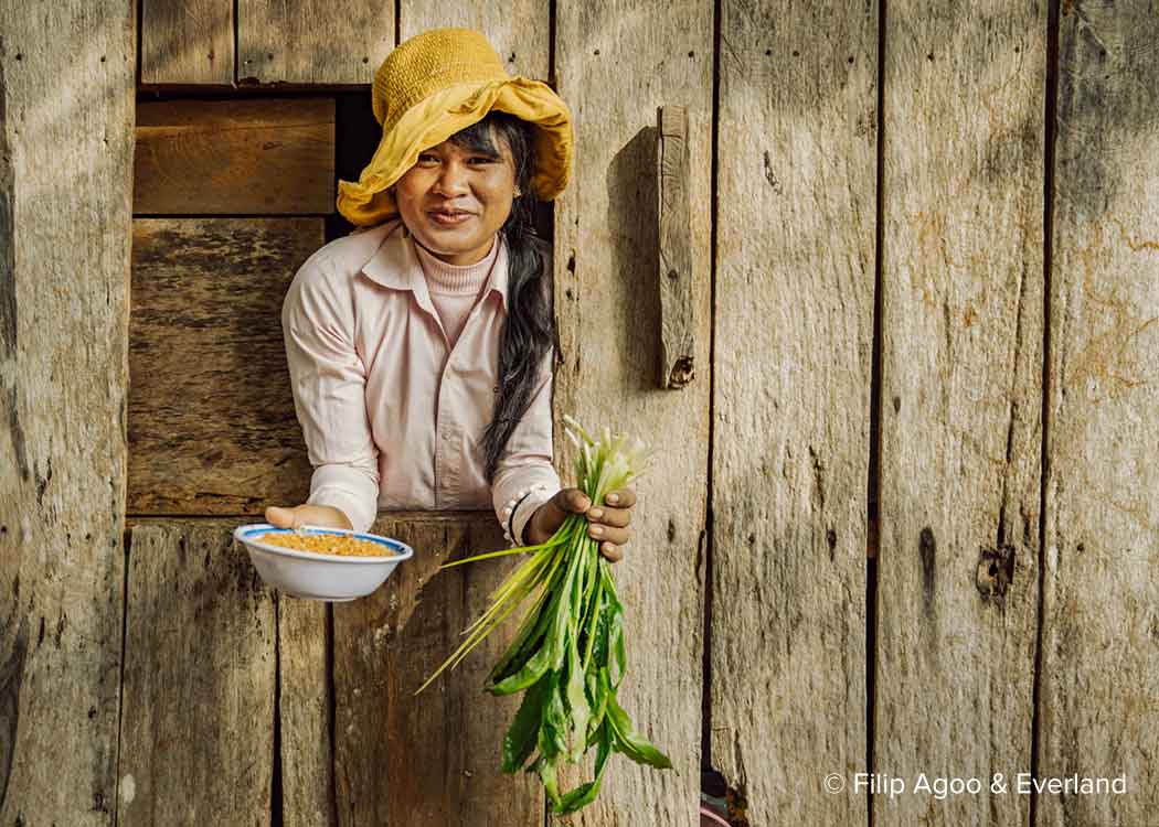 Woman holding food at restaurant, Keo Seima carbon offset project