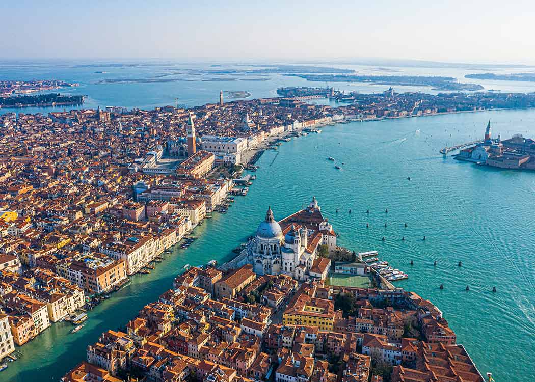 An aerial view of the historic city and tourism destination of Venice within the lagoon