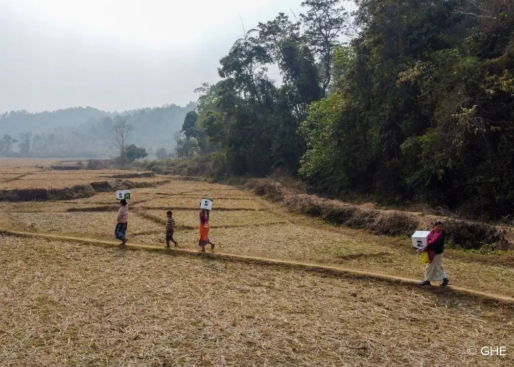 People carrying back the clean cookstoves in Garo Hills