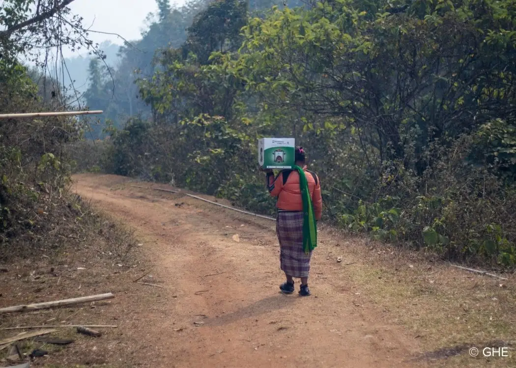 Woman carrying a clean cookstove