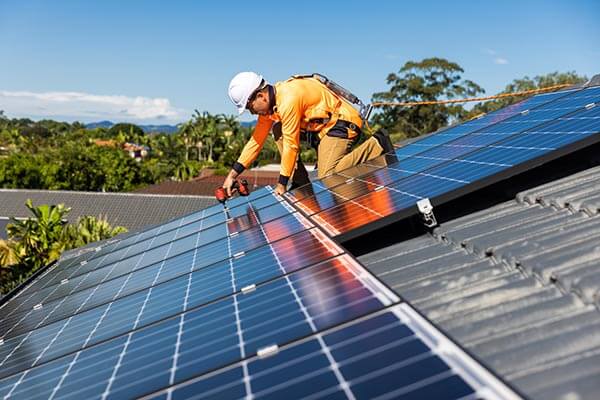 Solar panels getting installed on rooftop of building