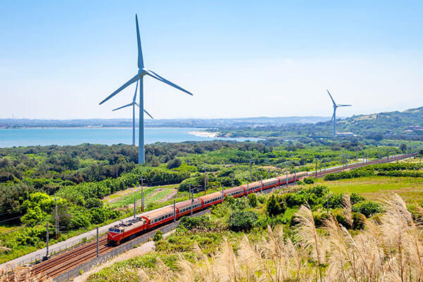 A train traveling by wind turbines in Taiwan