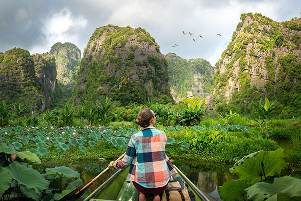 A tourist paddling through a picturesque park in Vietnam